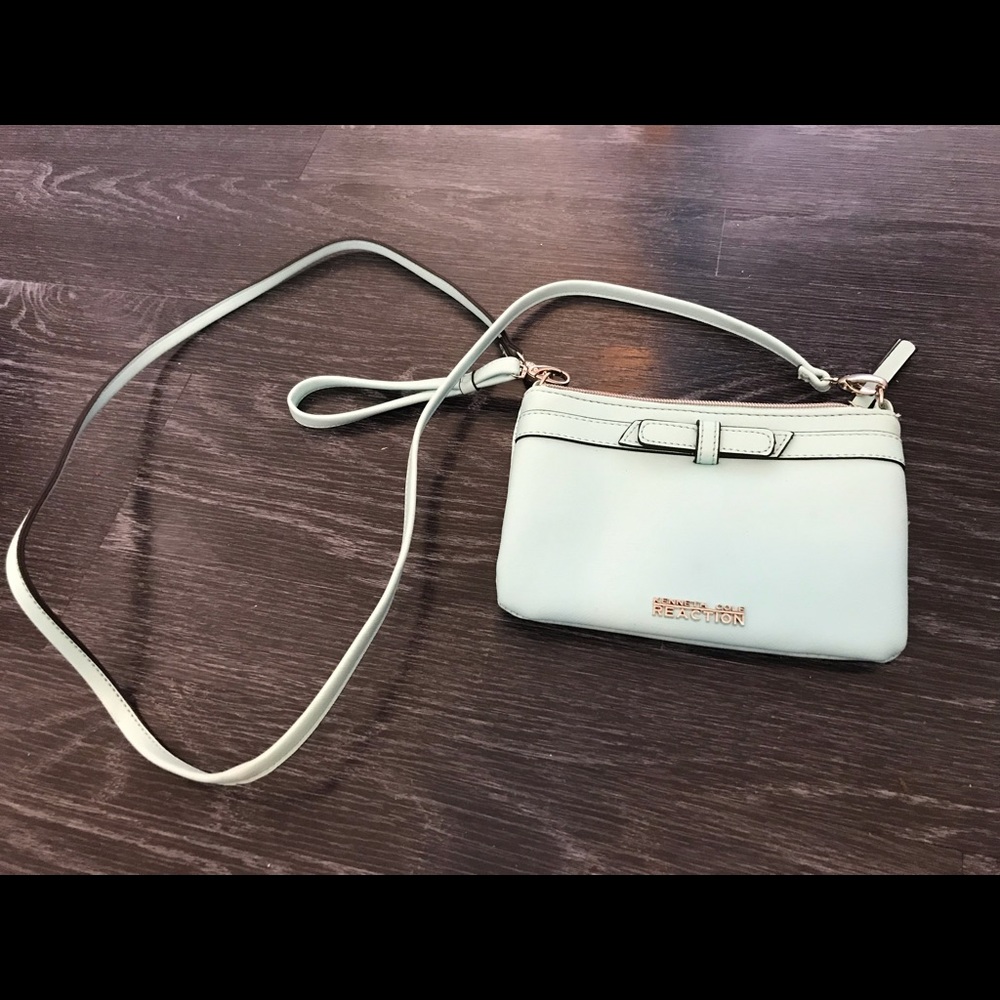 A light blue Kenneth Cole reactions crossbody bag